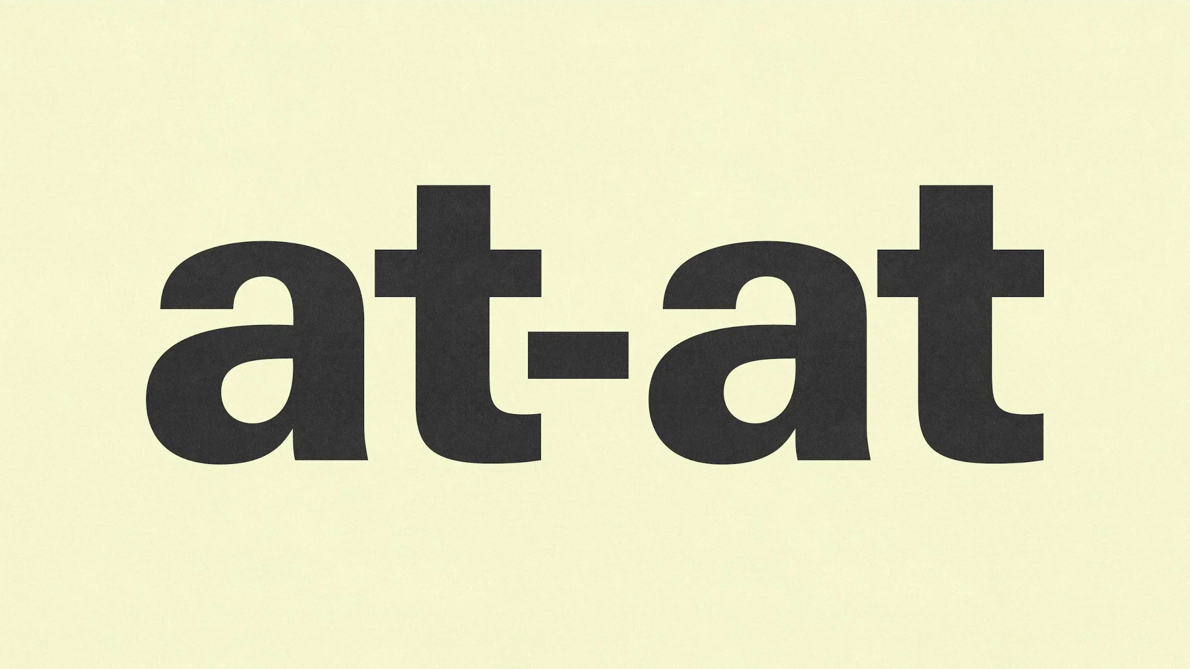 at-at — wordmark noir centré en gros caractères sur fond jaune pâle