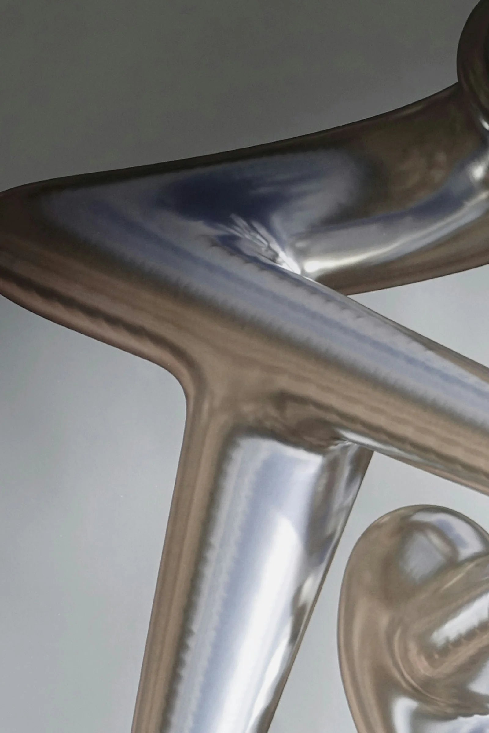 Face au néant — détail rapproché d'une forme 3D chromée aux reflets miroir, visuel de l'affiche